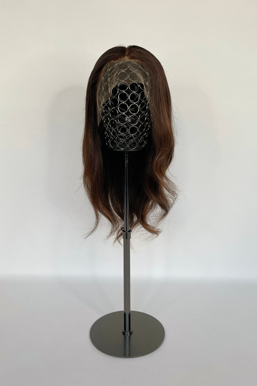 BHBD lace wig in a rich chestnut brown shade with soft, natural waves. Made with 100% real Remy hair, providing a realistic parting and seamless fit for versatile styling.