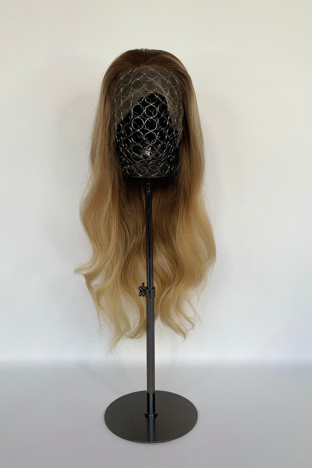 BHBD HD-lace wig in a honey blonde ombré shade with long, flowing waves. Made with 100% real Remy hair, providing a natural parting and seamless versatility for styling