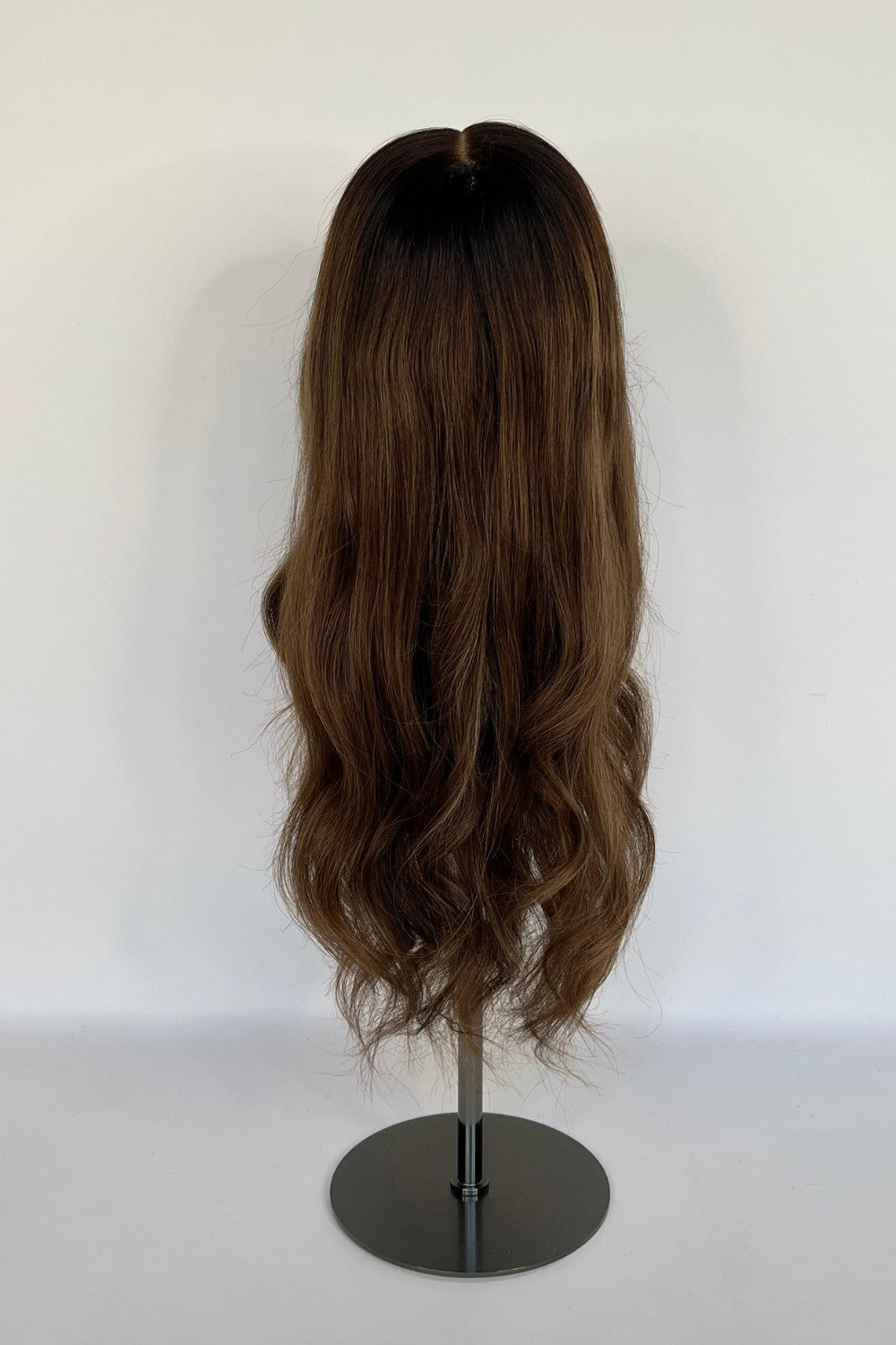 BHBD lace wig in a warm chestnut brown shade with soft, natural waves. Made with 100% real Remy hair, providing a seamless fit and natural parting for versatile styling options.